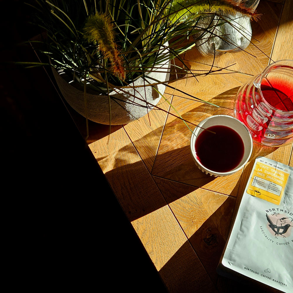 Filter coffee and a bag of North Side beans on a sunlit table